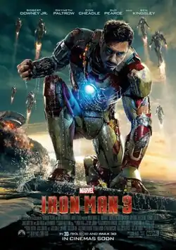Tony Stark, as Iron Man in his battle damaged suit sitting with water around him, while his house behind is destroyed. Stark's Iron Legion is flying, while the Marvel logo with the film's title, credits and release date are below.