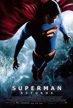 Superman above the United States at night; his shirt and tights are blue, with a yellow insignia with a red border and stylized "S" on his chest; his cape, briefs, and boots are red, and he wears a yellow belt with a similar insignia on the buckle as on his chest.